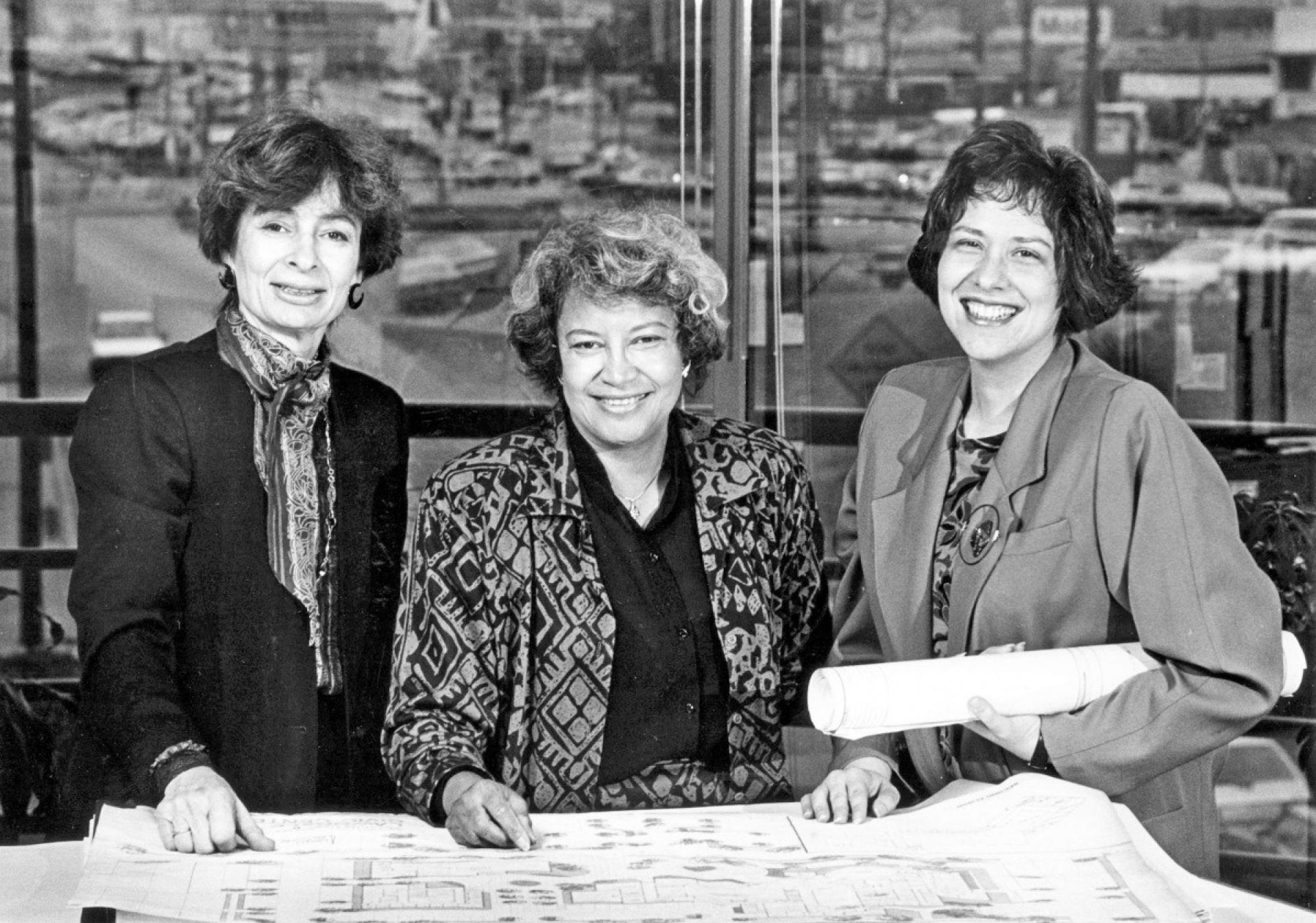 A 1986 staff file photo of architects (from left) Margot Siegel, Norma Sklarek and Katherine Diamond, looking over blueprints. | photo via Hufingtonpost