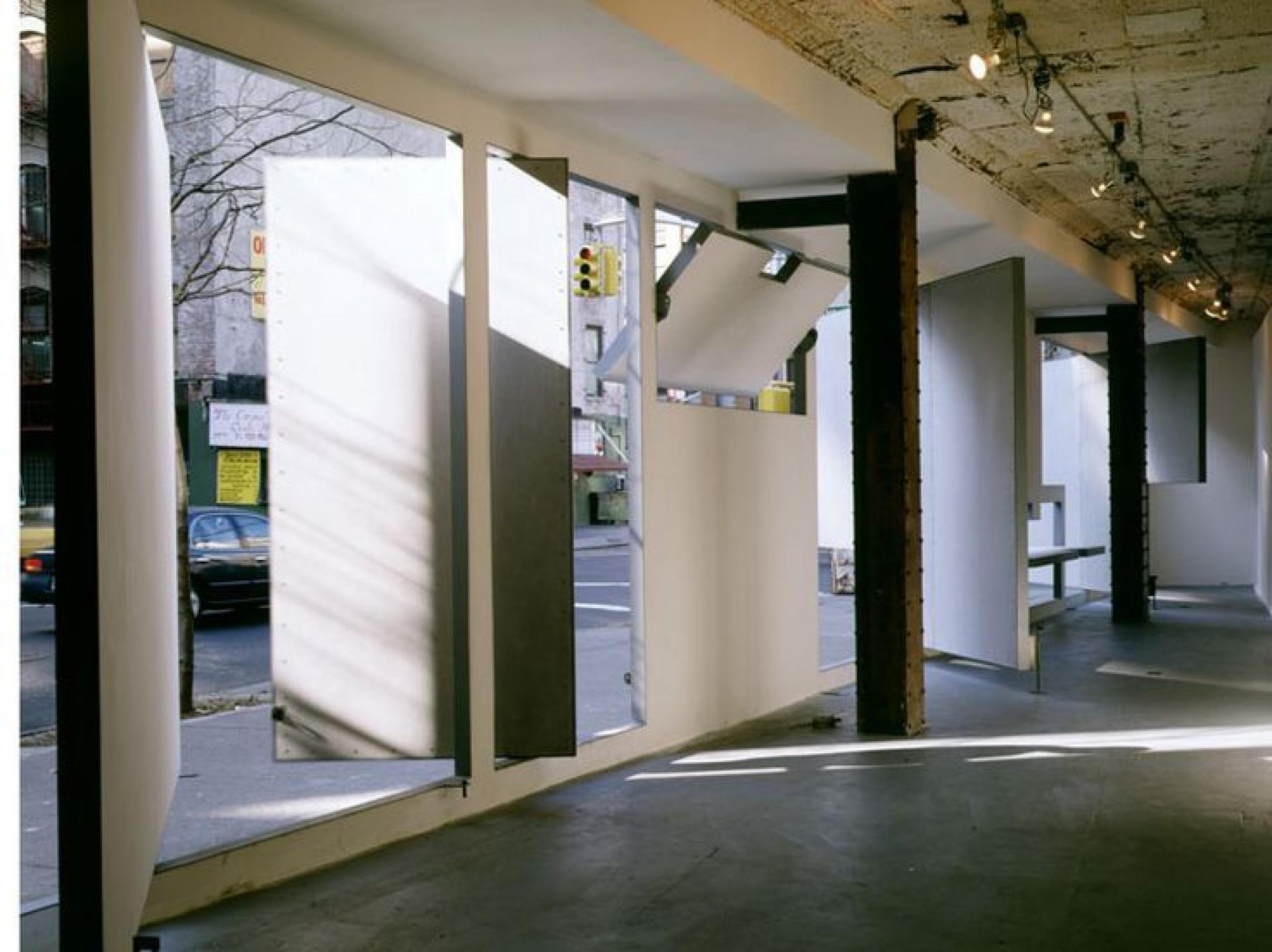At Storefront (1993), panels can be rotated to articulate an intimate interior venue or open to the New York street and its cacophony. | Photo via Paul Warchol
