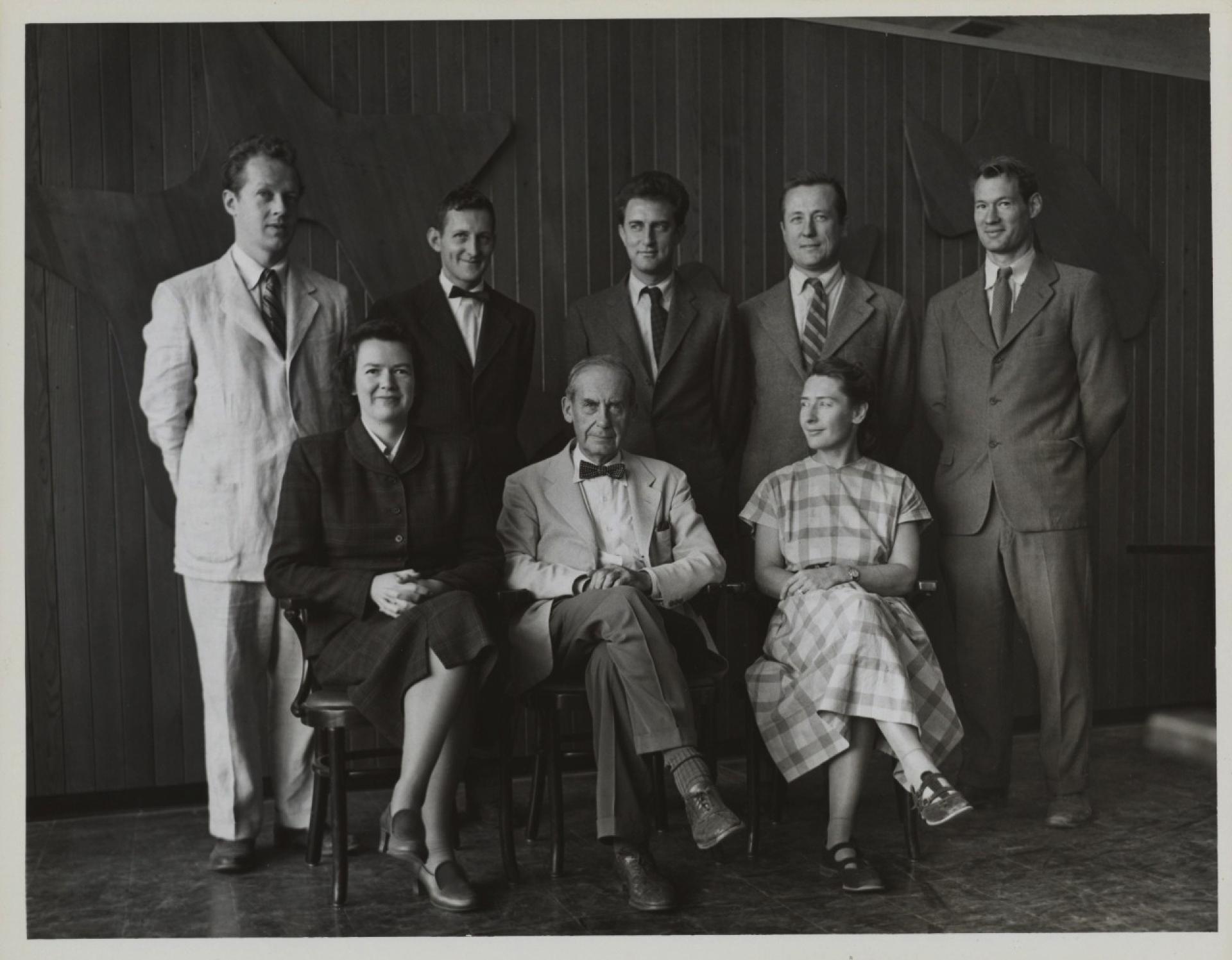 The Architects Collaborative (TAC) founding members from left to right: Robert S. McMillan (1916-2001), Norman C. Fletcher (1917-2007), Benjamin Thompson (1918-2002), Louis A. McMillen (1916-1998), John C. Harkness (1916-2016), Jean B. Fletcher (1915-1965), Walter Gropius (1883-1969), Sarah Harkness (1914-2013).