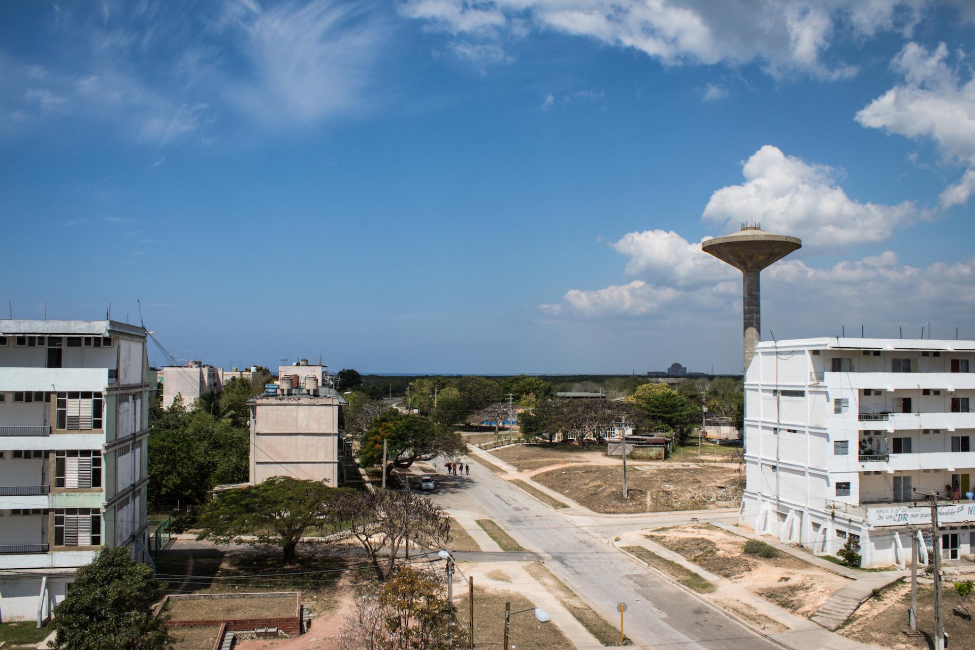 A handful of residents still live in Ciudad Nuclear surrounded on all sides by empty blocks, and with the unfinished power plant just visible on the horizon.