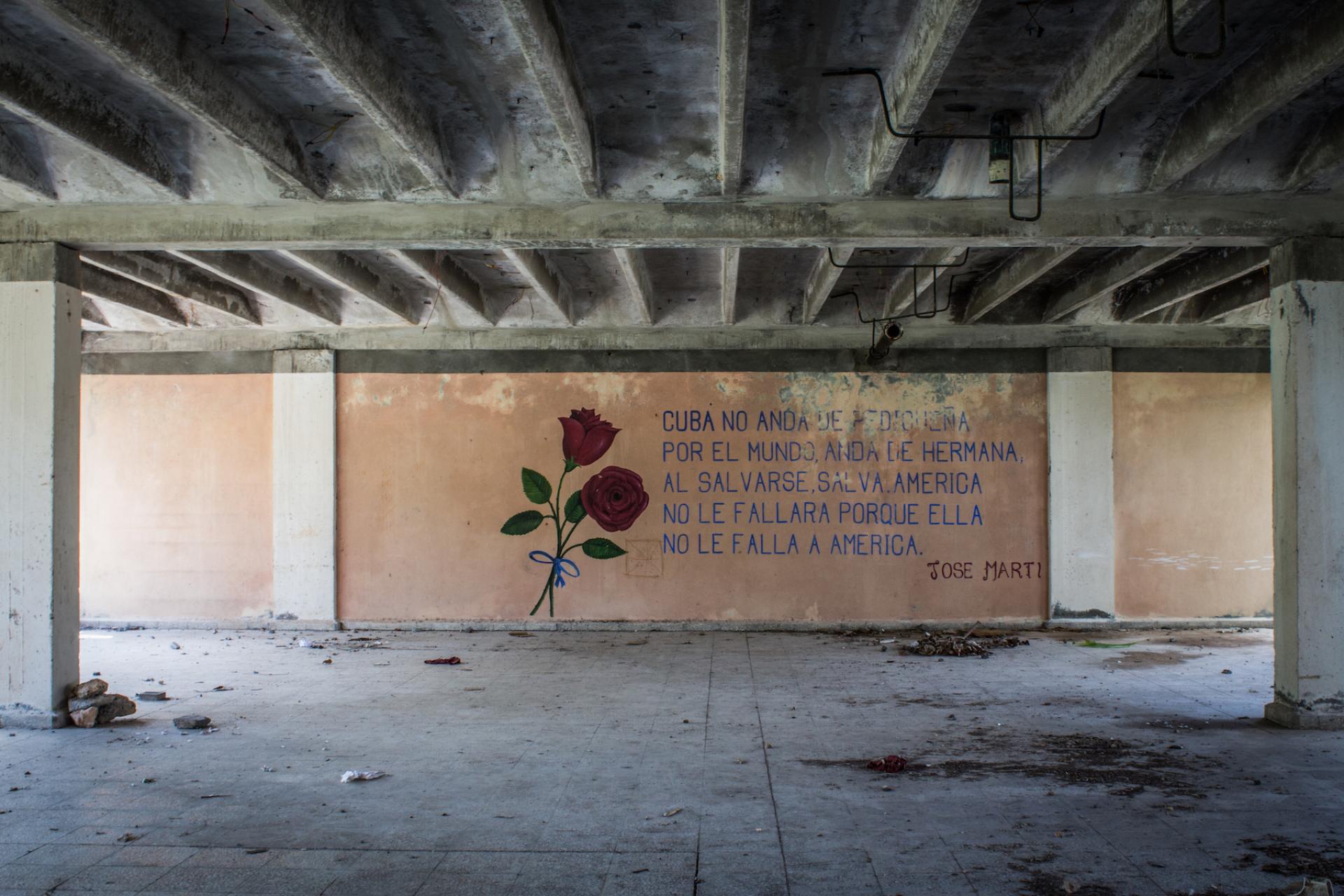 Poetry by José Martí appears on a wall in what might have been intended as a cafeteria.