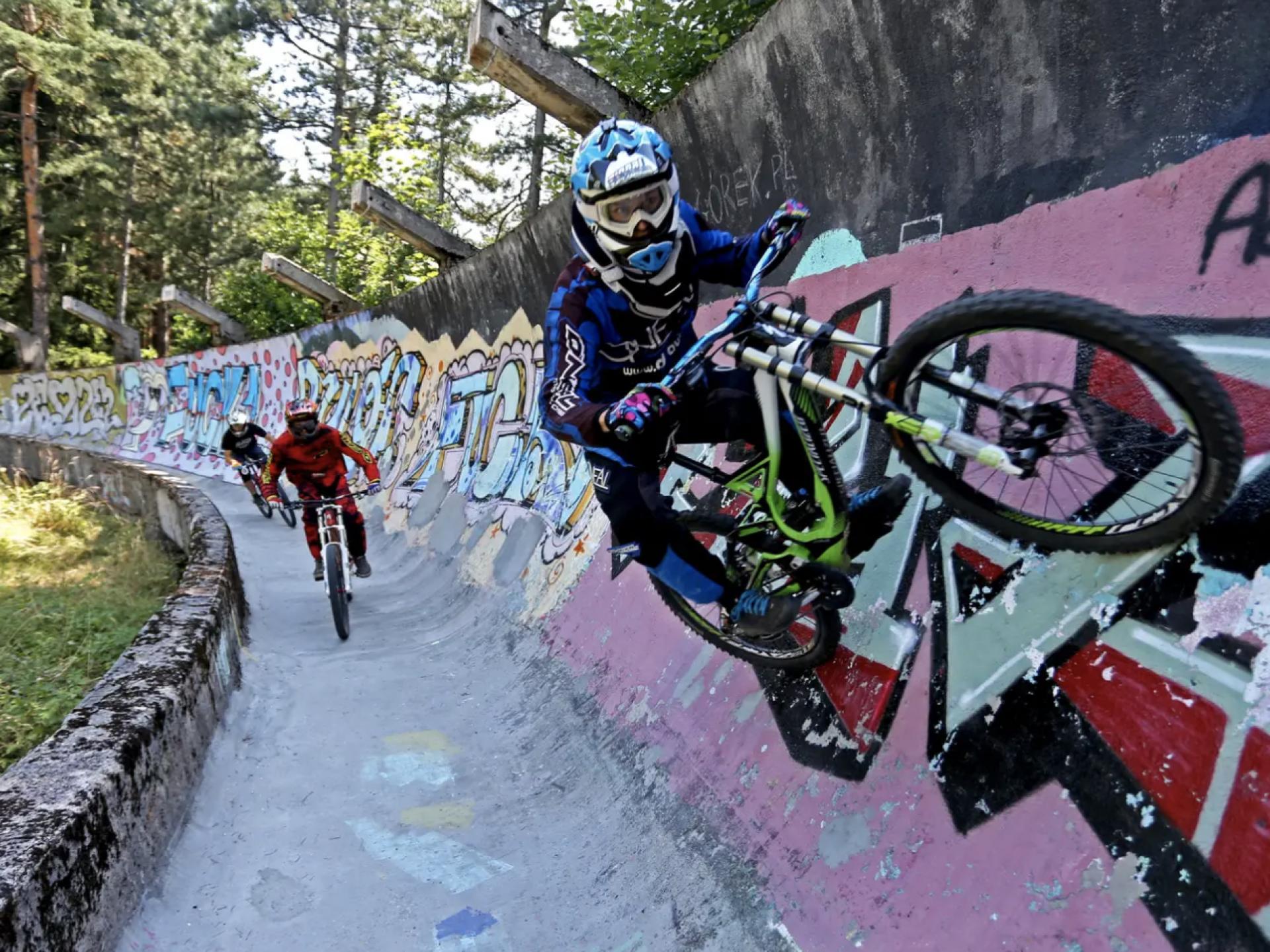 Downhill bikers train on the disused bobsled track from the 1984 Sarajevo Winter Olympics on Mt. Trebević near Sarajevo. | Photo © Dado Ruvić