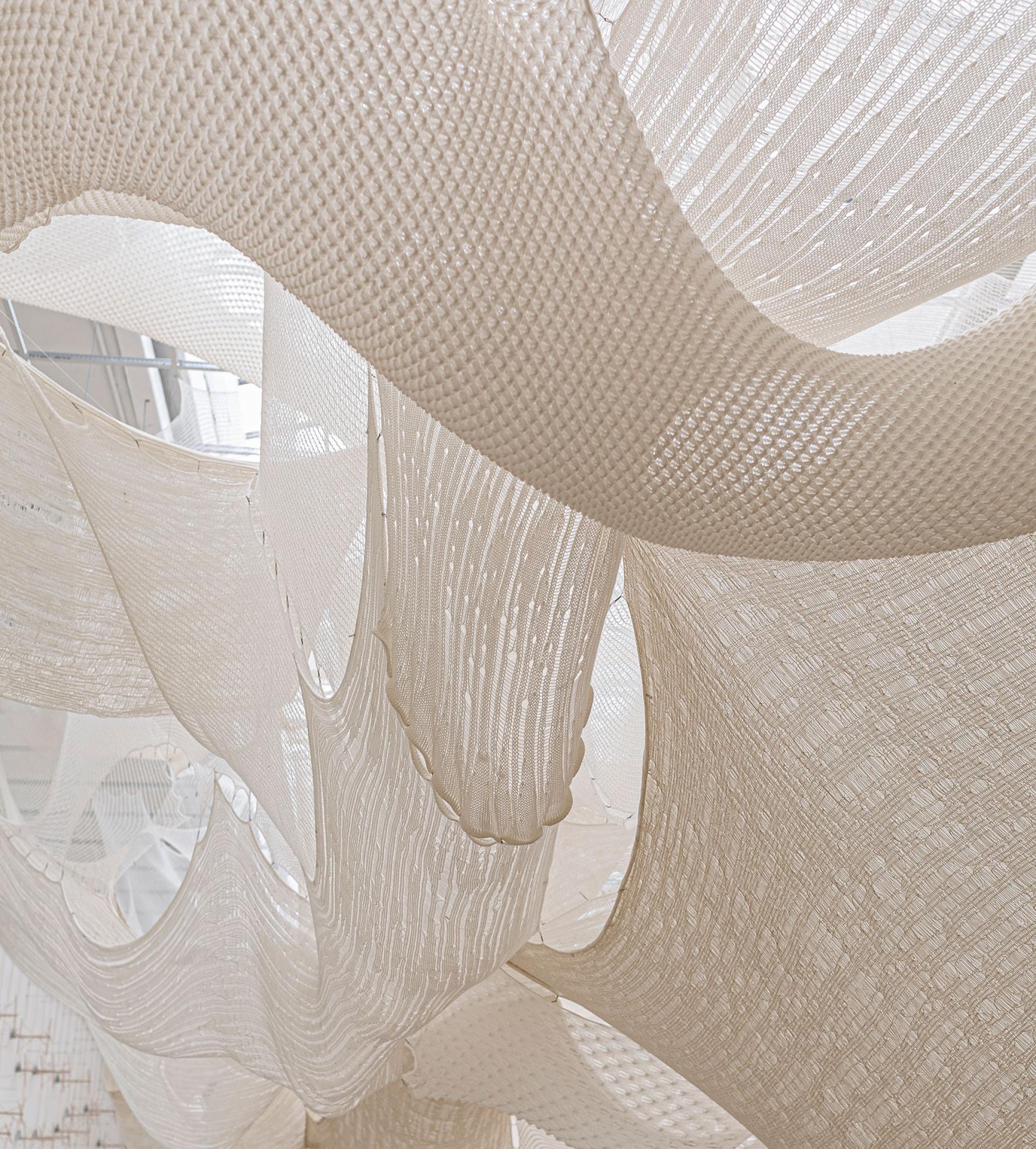 Human craft vs AI: In the Serbian Pavilion an exhibit crafted by designers are unwoven by algorithms until the space is empty. Image © Andres Ferro