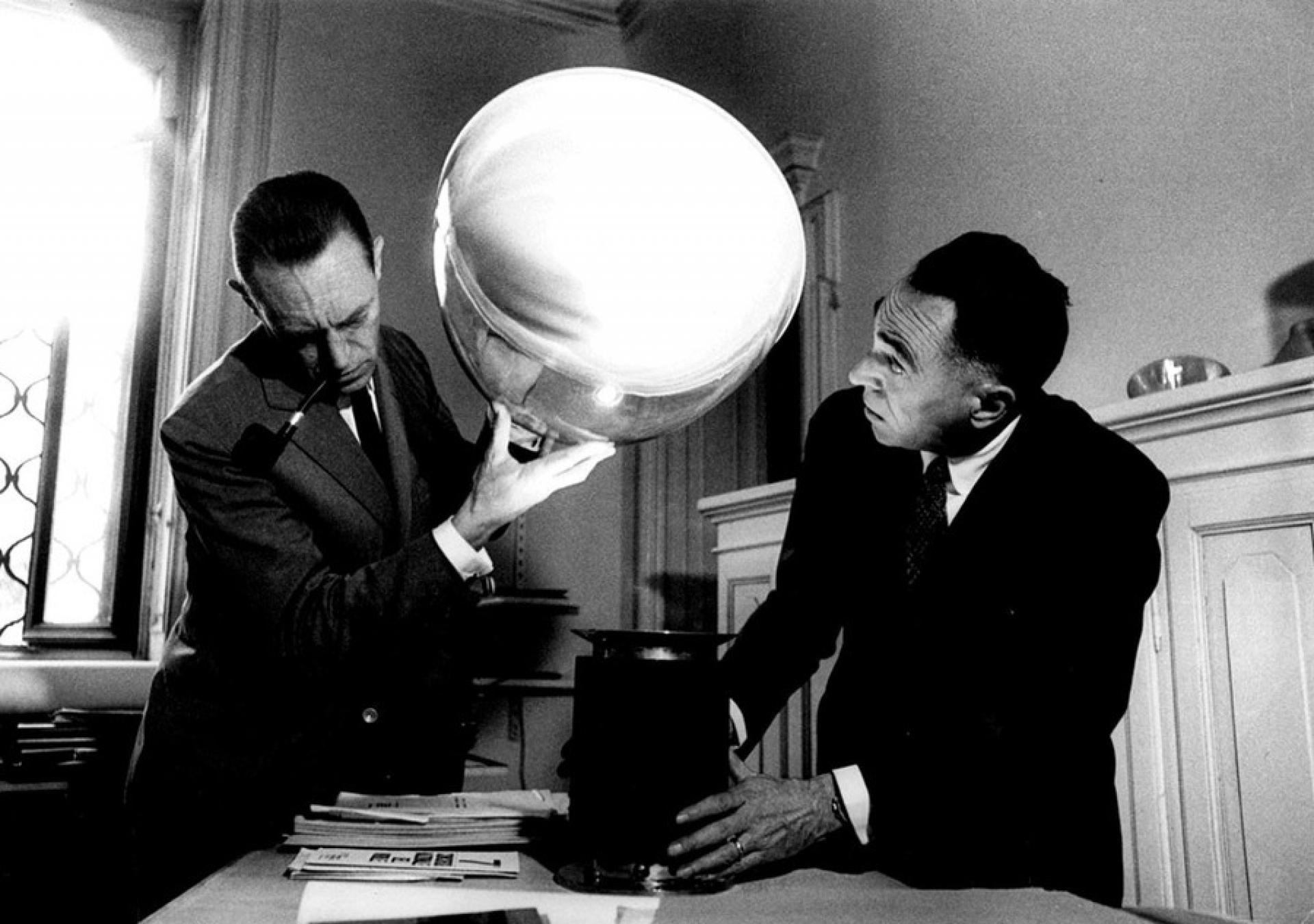 Pier Giacomo and Achille testing their Taccia Lamp, 1960s | Photo via Abitare
